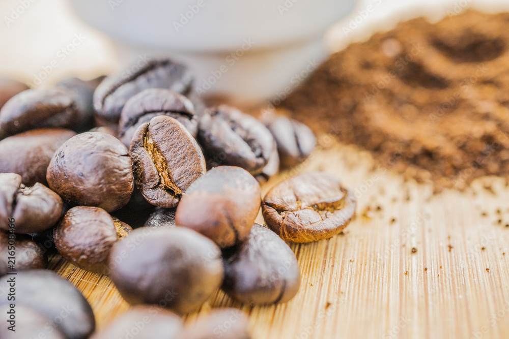 close-up coffee beans with cup on wooden rustic board close-up coffee beans with cup on wooden rustic board