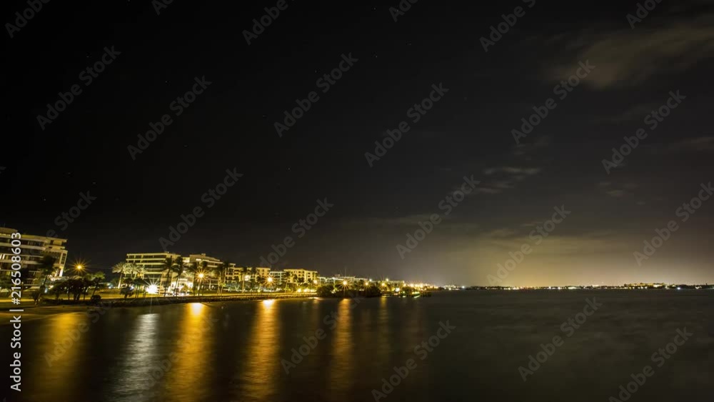 Time lapse at night of the clouds and city lights of Palm Beach, Florida reflecting on the water Time lapse at night of the clouds and city lights of Palm Beach, Florida reflecting on the water