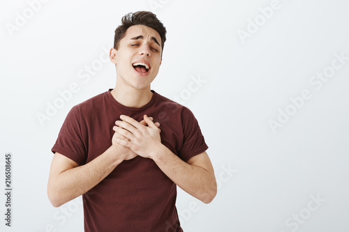 Photography Indoor shot of passionate good-looking boyfriend in trendy red t-shirt, holding