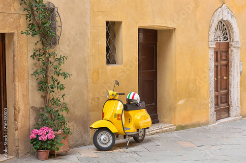 Fototapeta Naklejka Na Ścianę i Meble -  Yellow scooter on the street