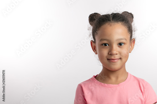 Billede på lærred closeup portrait of an adorable girl wearing two buns isolated on the white background
