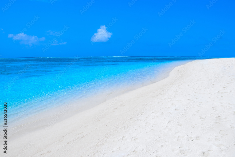 Lonely sandy beach with turquoise ocean and blue sky Lonely sandy beach with turquoise ocean and blue sky