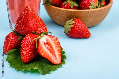 fresh strawberrysmoothie or milkshake on a delicately blue background photo