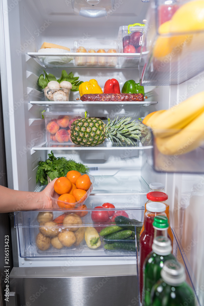 Person taking fresh oranges from fridge Person taking fresh oranges from fridge