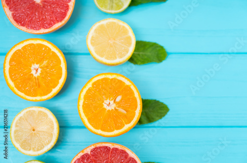 To rows of halved fresh citrus fruits