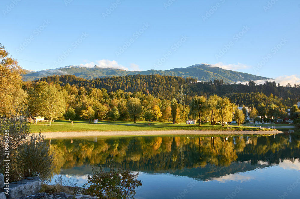Beautiful Mountains and a lake in autumn. Baggersee, Innsbruck, Austria. 