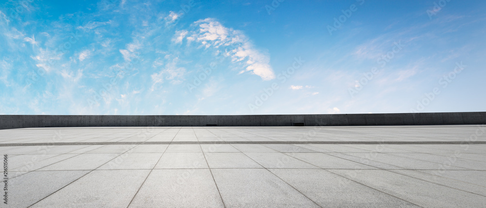 Clean square floor and blue sky with white clouds