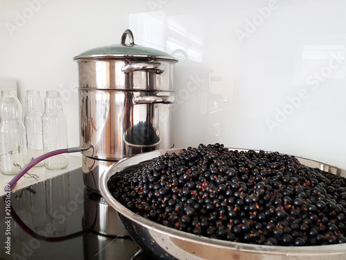 Εκτύπωση καμβά Black currant juice making by steam juicer pot in the kitchen