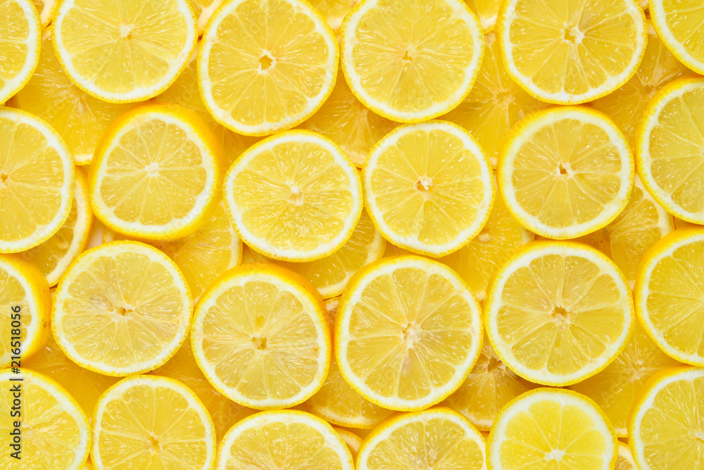 A slices of fresh juicy yellow lemons.  Texture background, pattern.