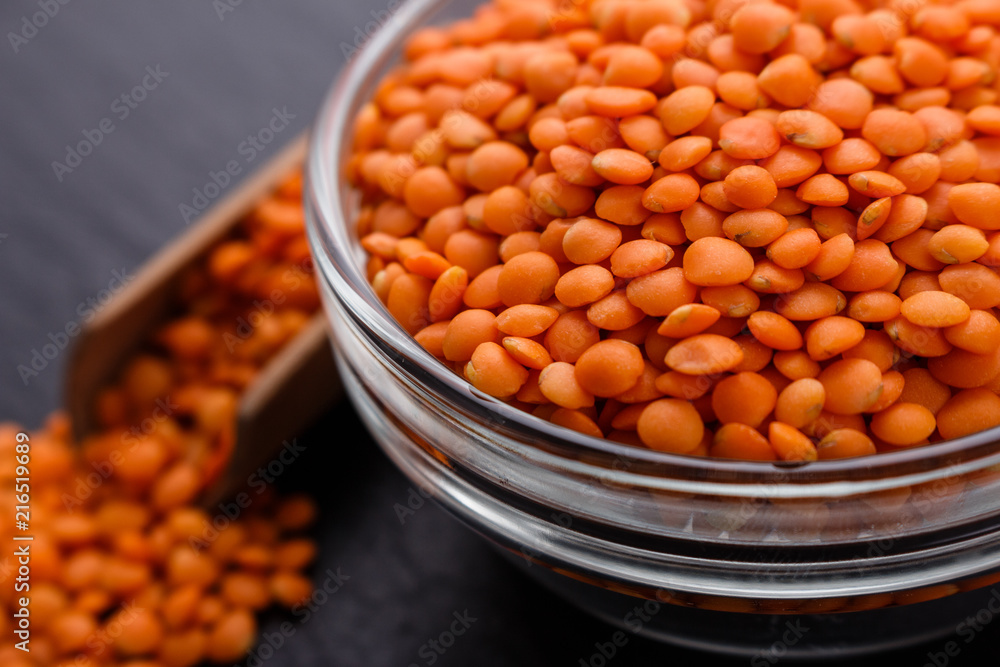 raw lentils on a dark stone background raw lentils on a dark stone background