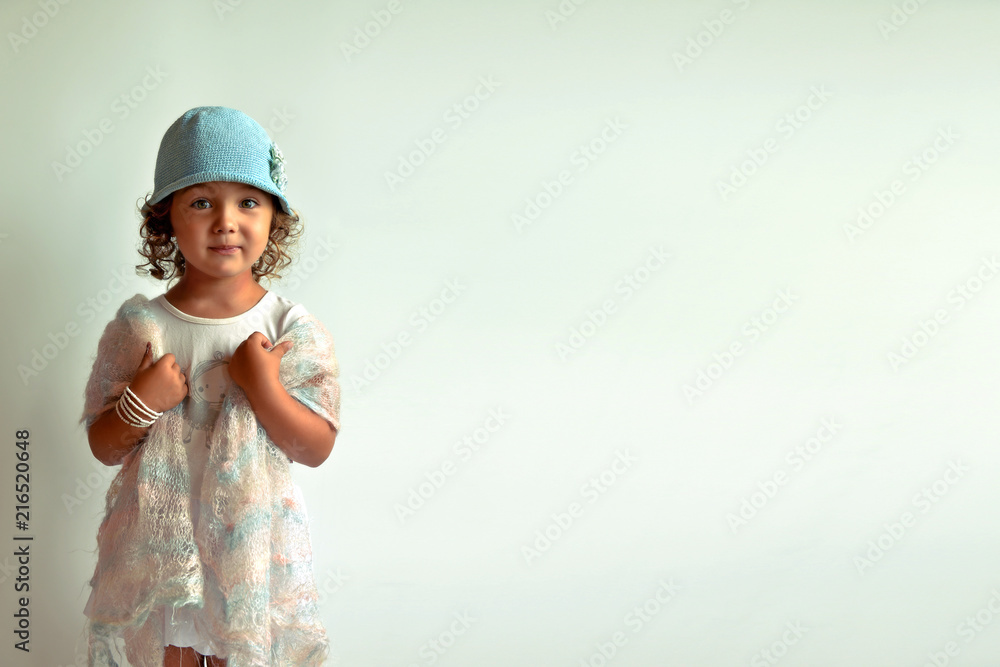 Glamorous girl. Children's fashion. Girl in blue cap on a white background. Glamorous girl. Children's fashion. Girl in blue cap on a white background.
