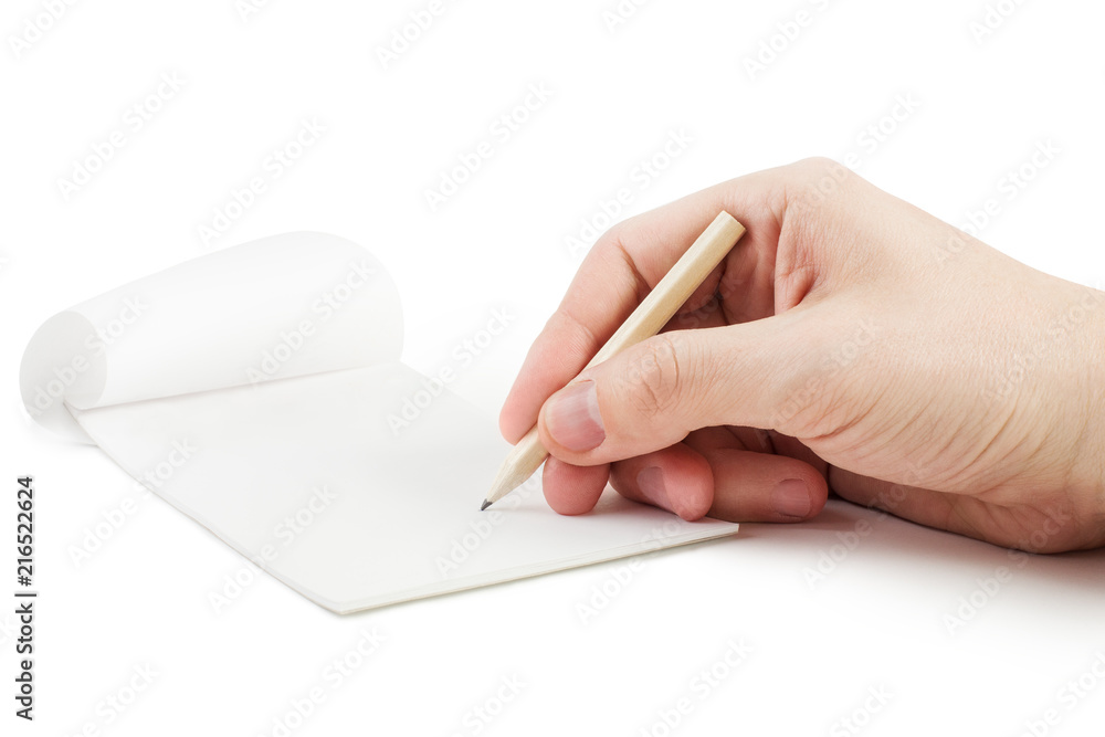 Close-up view of a male hand writing or drawing smth. with a simple pencil into empty notepad, isolated on white background Close-up view of a male hand writing or drawing smth. with a simple pencil into empty notepad, isolated on white background
