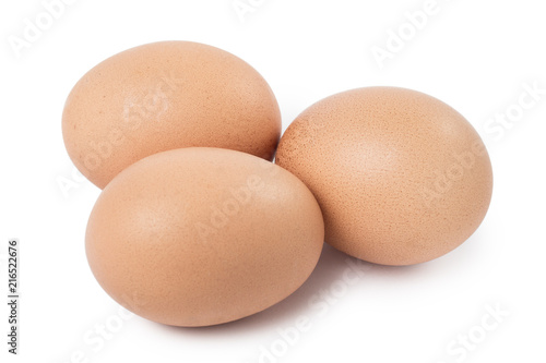 Three brown eggs, isolated on white background