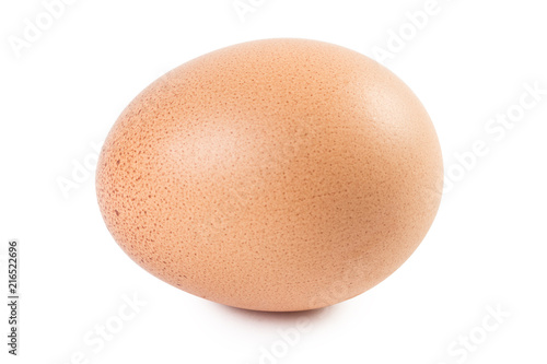 Close-up view of a brown egg with freckles, isolated on white background