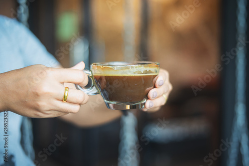 close up of a woman hands holding a coffee cup