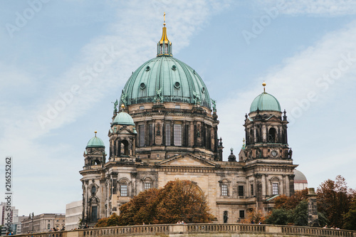 The Berlin Cathedral is called Berliner Dom against the blue sky. Beautiful old building in the style of neoclassicism and baroque with cross and sculptures. Berlin, Germany