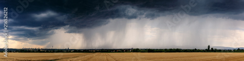 Dramatic thundercloud over a wheat field photo