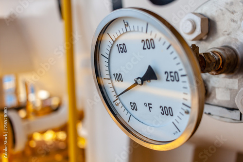 Thermometer, Temperature gauge or temperature indicator reading seventy five Fahrenheit (°F) in offshore oil and gas refinery process operation industry.
