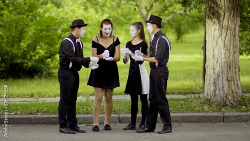 Mimes play Rock Paper Scissors in the park photo