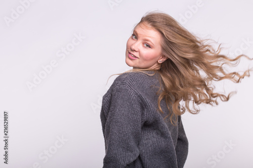 Portrait of beautiful young european woman with blond flatterig hair.