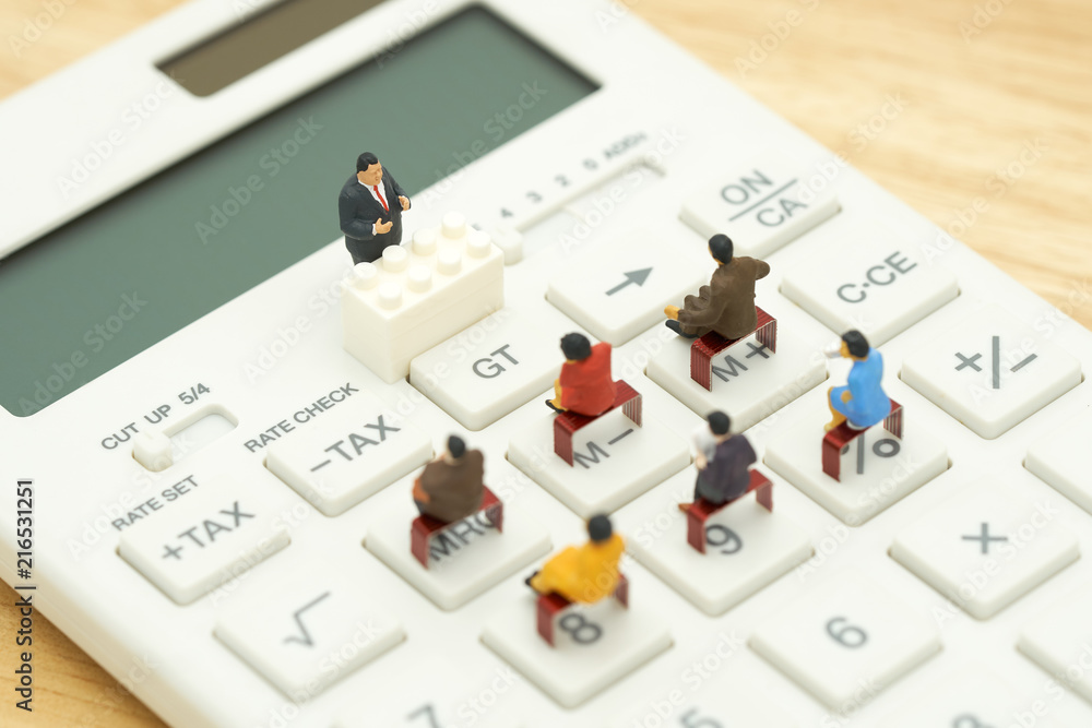 Fototapeta premium Miniature people Pay queue Annual income (TAX) for the year on calculator. using as background business concept and finance concept with copy space for your text or design.