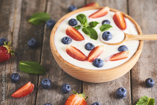 Homemade Greek yogurt or sour cream in a wooden bowl