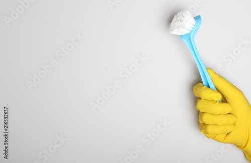 yellow glove and blue brush