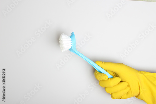 yellow glove and blue brush