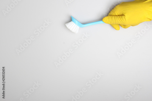 yellow glove and blue brush