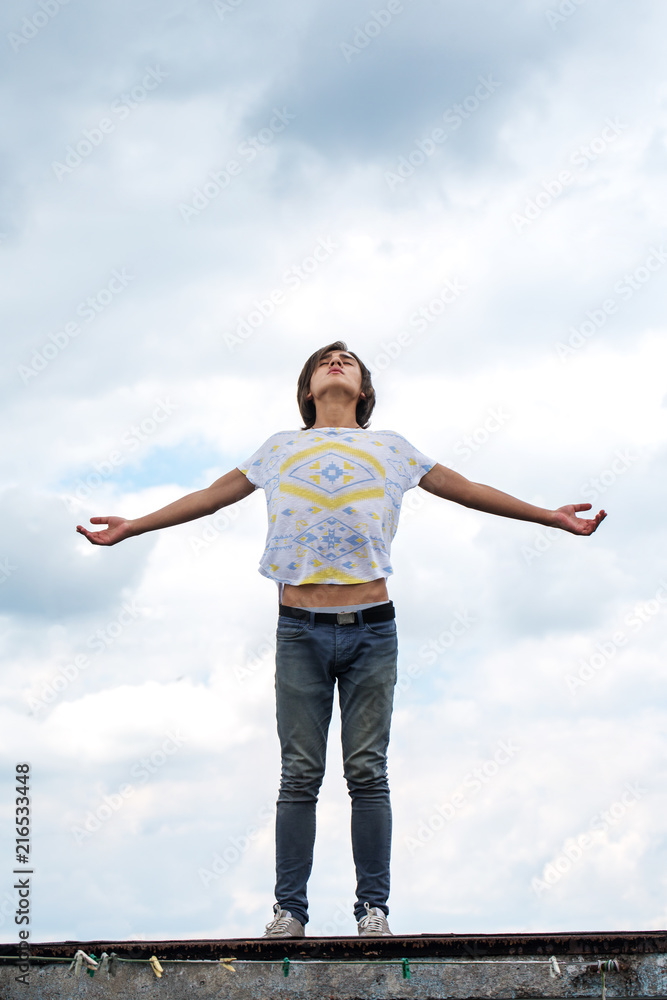 guy with open hands against the background of clouds guy with open hands against the background of clouds