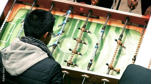 Group of Teenagers Playing the Metegol in La Paz (Bolivia). photo