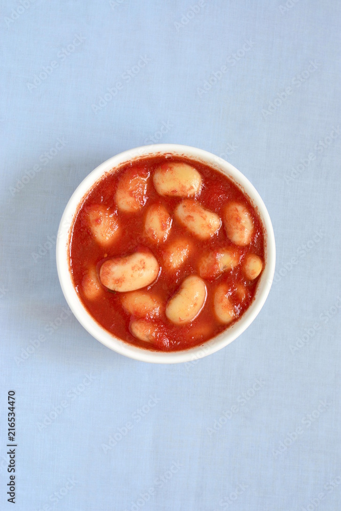 Obraz White beans in tomato sauce, top view