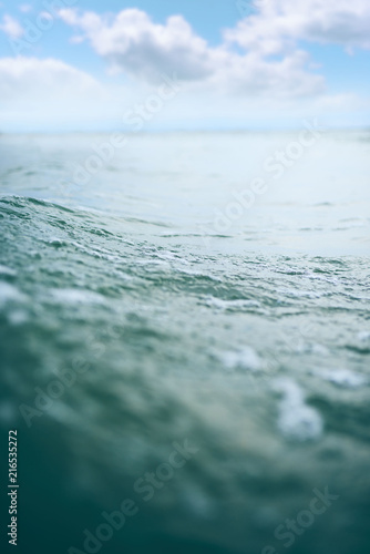 Close-up view of a turquoise sea waves on the beach.