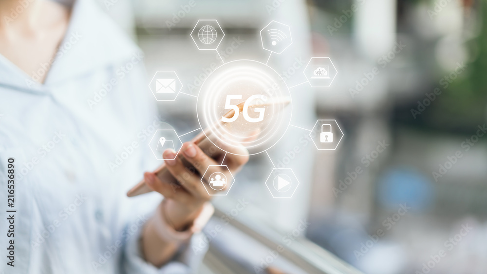 Woman holding smartphone to screen icon 5G. Concept of future and trend internet for easy access to information. Woman holding smartphone to screen icon 5G. Concept of future and trend internet for easy access to information.