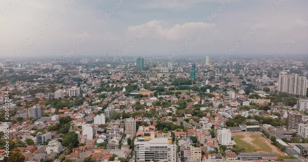 Drone flying backwards high above city of Colombo, Sri Lanka. Aerial panoramic view of amazing Asian cityscape skyline. Drone flying backwards high above city of Colombo, Sri Lanka. Aerial panoramic view of amazing Asian cityscape skyline.