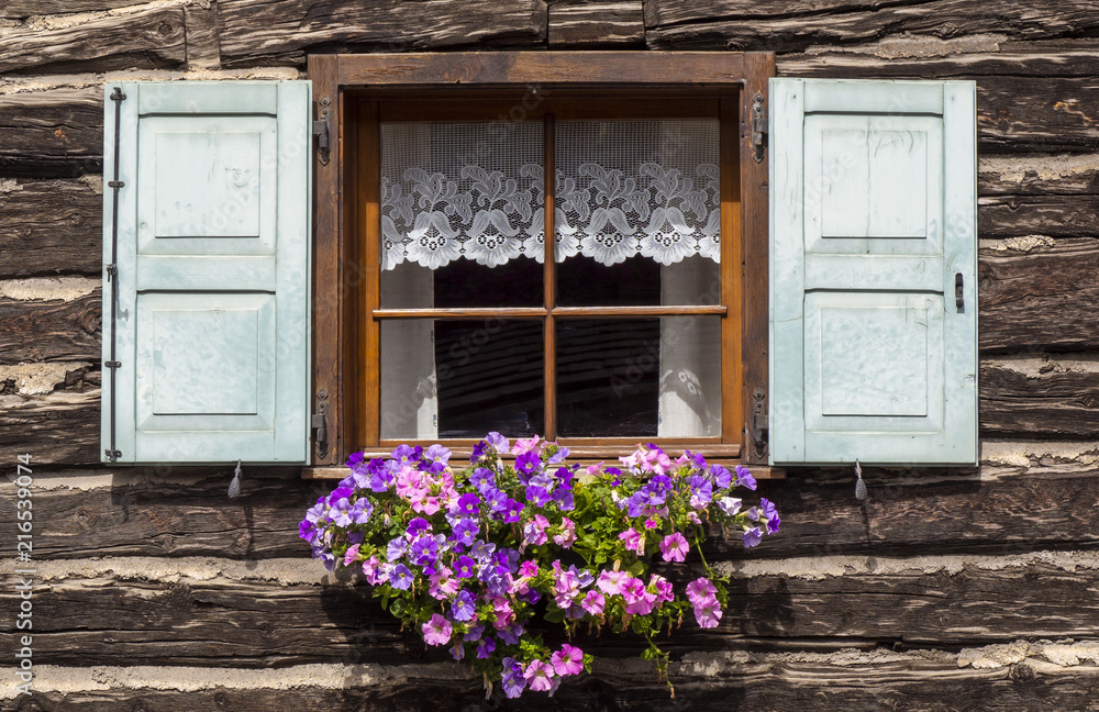 Traditional flowered windows at the Italian Alps and dolomites