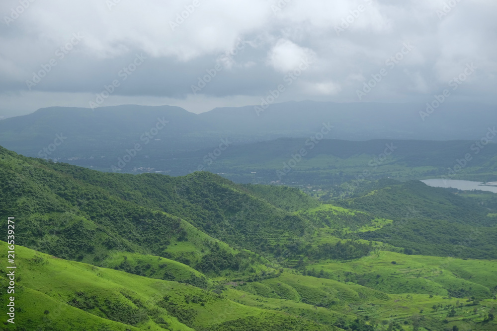 Lush green monsoon nature landscape mountains, hills, Purandar, Pune, Maharashtra, India Lush green monsoon nature landscape mountains, hills, Purandar, Pune, Maharashtra, India