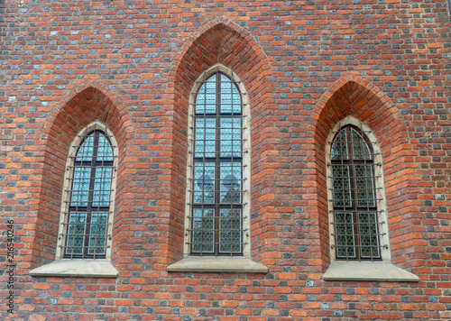 high and narrow Windows in the old brick house