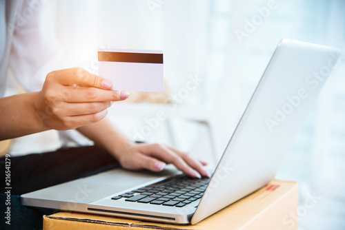 Woman hands holding credit card for online shopping or ordering product from internet when using laptop. Business and Payment concept. E-commerce and internet security concept. Home office and relax
