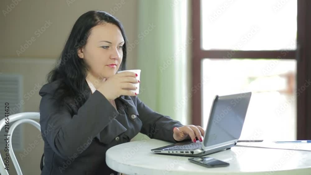 Business woman working on laptop in cafe. Panorama from right to left Business woman working on laptop in cafe. Panorama from right to left