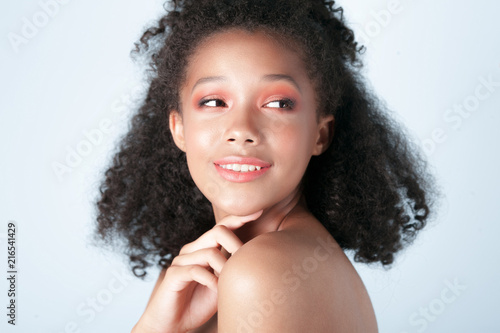 Young smiling black girl with clean perfect skin close-up