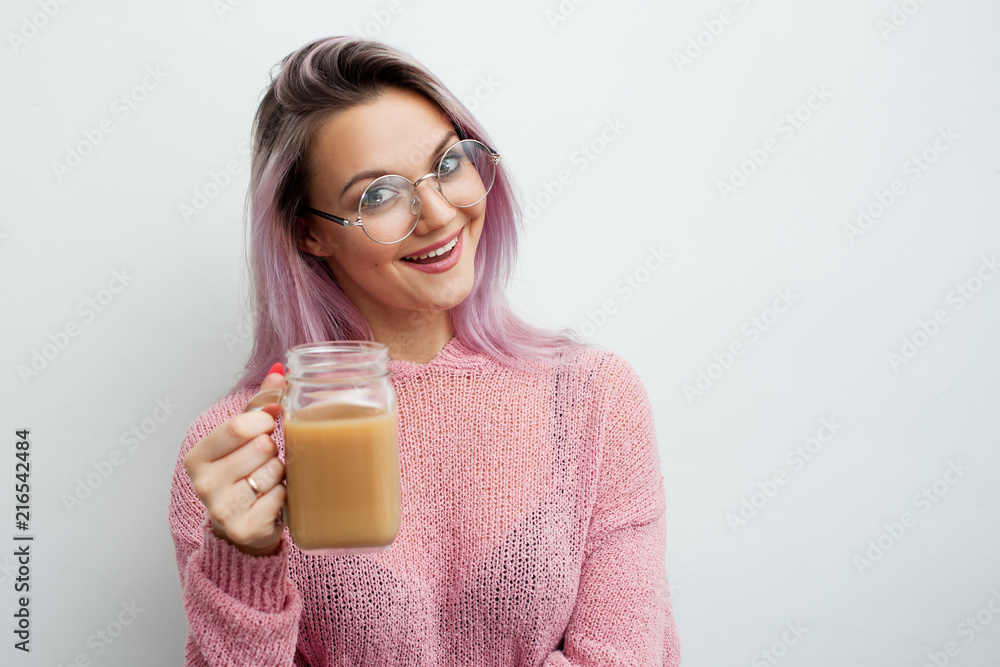 Trendy young woman drinking coffee milkshake. Trendy young woman drinking coffee milkshake.