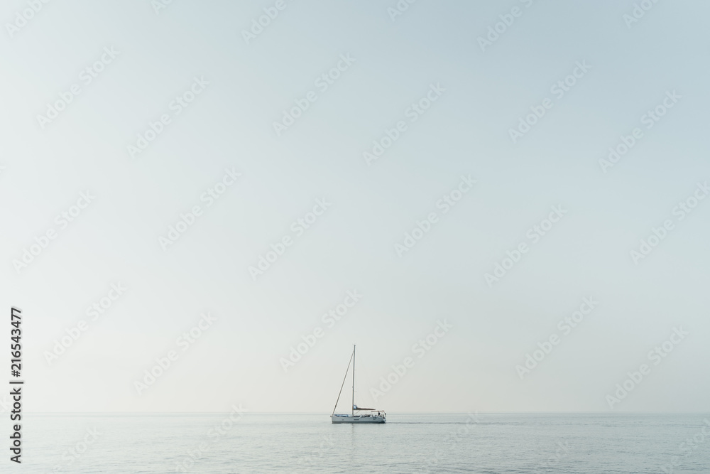 One lonely yacht in a blue sea horizontal panoramic