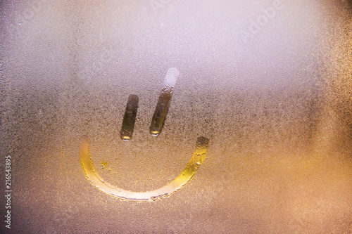Foggy glass on window with drawn Smiley happy concept