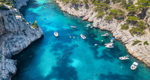 Yachts at the sea in France. Aerial view of luxury floating boat on transparent turquoise water at sunny day.