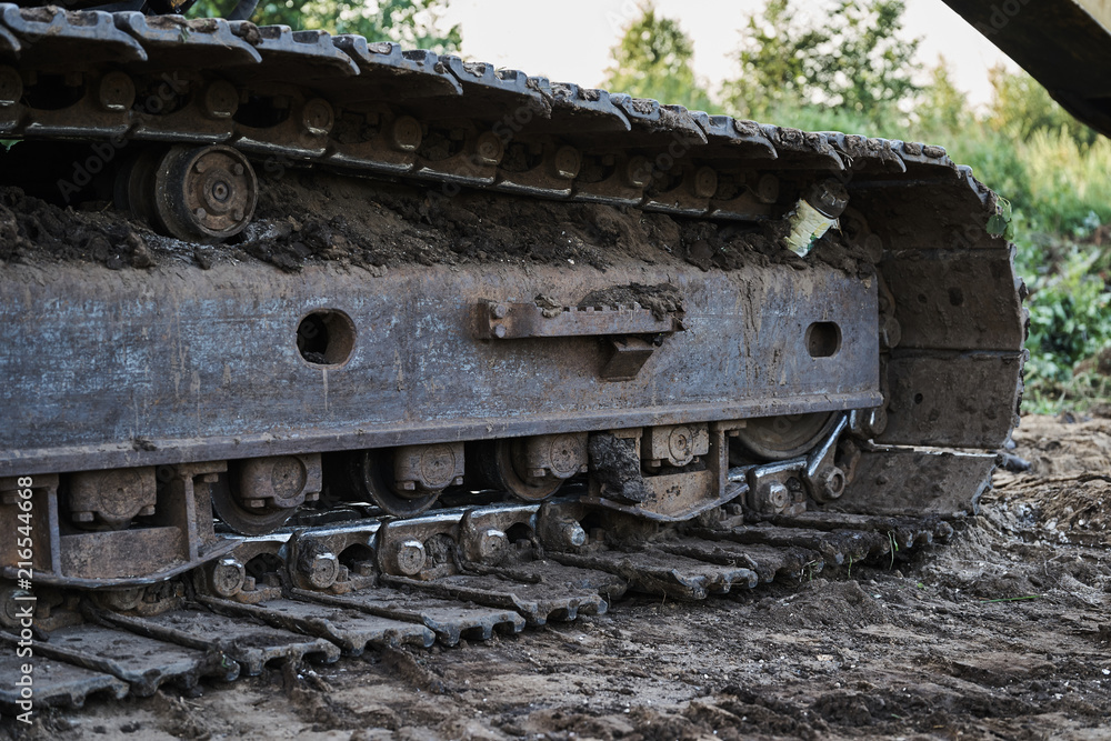 dirty tracks of old excavator close up