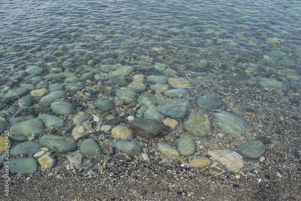 Underwater stones and pebbles. Clear and quiet sea water.