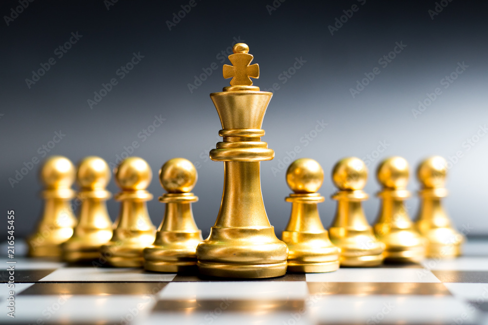 Gold king chess piece stand in front of pawn on black background (Concept of leadership, management) Gold king chess piece stand in front of pawn on black background (Concept of leadership, management)