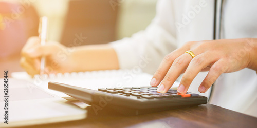 close up on finger hand press on calculator for computing,working woman concept