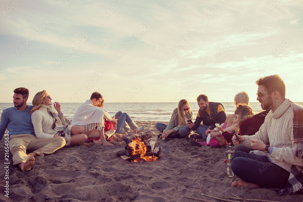 Friends having fun at beach on autumn day Friends having fun at beach on autumn day